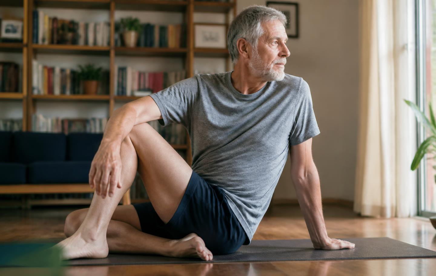 A woman in her sixties doing her daily mobility routine on a mat at home